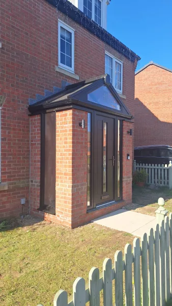 Contemporary porch with windows and glazed panels.