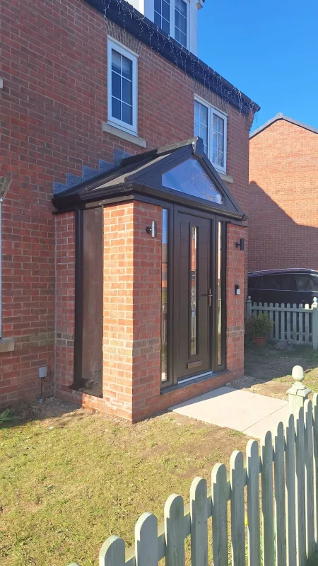 Contemporary porch with windows and glazed panels.