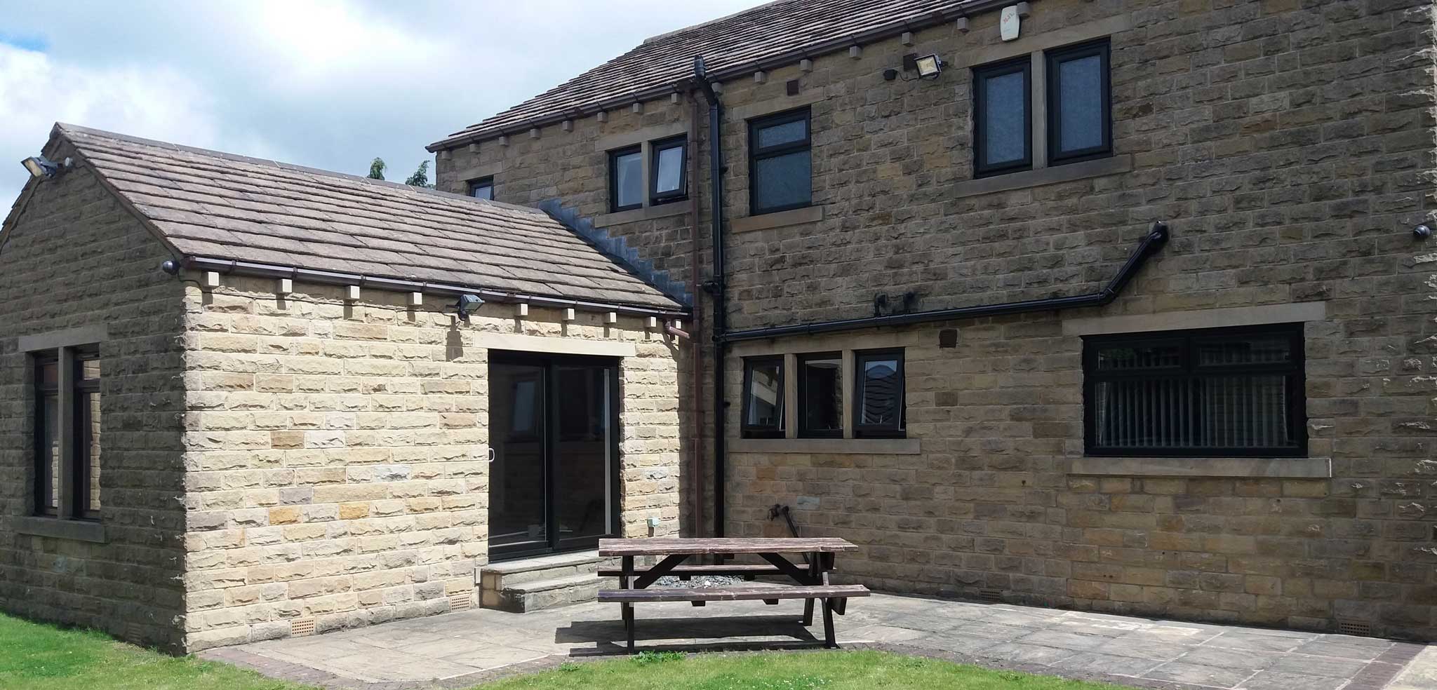replacement windows otley in country cottage with bench in garden